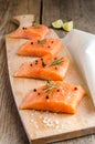 Raw salmon steaks on the wooden board Royalty Free Stock Photo