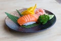 Raw salmon sushi on black plate - Japanese food