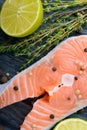 Raw salmon with thyme, pepper and lime Royalty Free Stock Photo