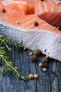 Raw salmon with thyme and pepper on a wooden board. close-up Royalty Free Stock Photo