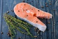 Raw salmon with thyme and pepper on a wooden board. close-up Royalty Free Stock Photo