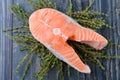 Raw salmon with thyme on a wooden board. closeup Royalty Free Stock Photo