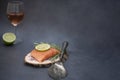 Raw salmon on wooden piece, rose wine