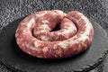 raw sausage in a round shape for grilling or roasting