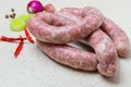 Raw sausage with spices on a light table Royalty Free Stock Photo