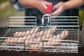 Fresh sausage grilling outdoors on a barbecue grill Royalty Free Stock Photo