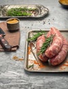 Raw sausages for grilling on a iron tray close up Royalty Free Stock Photo