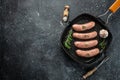 Raw sausages and ingredients on the grill pan ready to cook. Grilling food, bbq, barbecue. place for text, top view Royalty Free Stock Photo