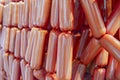 Raw sausages links on racks in modern meat processing factory