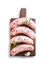 Raw Sausages with rosemary on wooden board Royalty Free Stock Photo