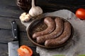 Raw sausages in the skin composition top and side view with vegetables and herbs on a dark tree Royalty Free Stock Photo