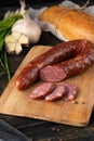 Raw sausages in the skin composition top and side view with vegetables and herbs on a dark tree Royalty Free Stock Photo