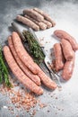 Raw Sausages variation - Beef, pork, lamb and chicken meat on a butcher table with rosemary and thyme. White background. Top view Royalty Free Stock Photo