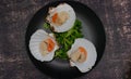 raw scallops ready for cooking on black plate and dark background Royalty Free Stock Photo
