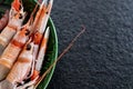 Raw scampi on green plate. Fresh raw fish food for luxury dinner Royalty Free Stock Photo