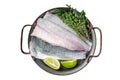 Raw Sea Bass fillet, Labrax fish with herbs and lime. Isolated, white background.