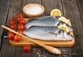 Raw sea bass on a wooden board Royalty Free Stock Photo