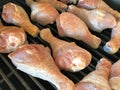 Raw seasoned chick legs on grill