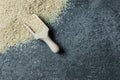 Raw sesame seeds in wooden shovel on grey rustic table Royalty Free Stock Photo