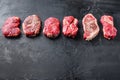 Raw set of rump, top blade, chuck roll beef steak cut, on black textured background, side view with space for text Royalty Free Stock Photo