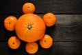 Raw several mandarins and orange isolated on black wooden table