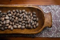 Raw in shell Pecan nuts in a wooden bowl on a wood table Royalty Free Stock Photo