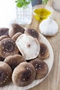 Raw shiitake mushrooms in the kitchen with parsley, olive oil and garlic. Mushroom photography.