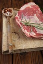 Raw shoulder lamb on wooden board and table Royalty Free Stock Photo