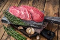 Raw Shoulder Top Blade beef meat steaks on a wooden butcher board with herbs. wooden background. Top View Royalty Free Stock Photo