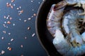 Raw shrimp in a frying pan top view on a black background Royalty Free Stock Photo