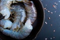 Raw shrimp in a frying pan top view on a black background Royalty Free Stock Photo