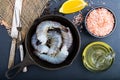 Raw shrimp in a frying pan top view on a black background Royalty Free Stock Photo