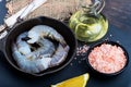 Raw shrimp in a frying pan top view on a black background Royalty Free Stock Photo