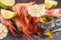 Raw shrimp, garlic, lime, curry and sea salt on a dark wooden background Royalty Free Stock Photo