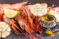 Raw shrimp, garlic, lime, curry and sea salt on a dark wooden background Royalty Free Stock Photo