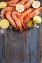 Raw shrimp, garlic, lime, curry and sea salt on a dark wooden background Royalty Free Stock Photo