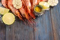 Raw shrimp, garlic, lime, curry and sea salt on a dark wooden background Royalty Free Stock Photo