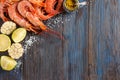 Raw shrimp, garlic, lime, curry and sea salt on a dark wooden background Royalty Free Stock Photo