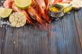 Raw shrimp, garlic, lime, curry and sea salt on a dark wooden background Royalty Free Stock Photo