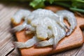 Raw shrimp on wooden cutting board background for cooking / close up fresh shrimps or prawns Seafood shelfish Royalty Free Stock Photo