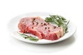 Raw sirloin steak with rosemary and spices on plate Royalty Free Stock Photo