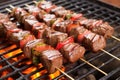 raw skewered pieces of marinated beef on a grill