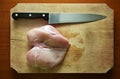 Raw skinless chicken breast with knife Royalty Free Stock Photo