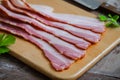 Raw sliced bacon on wooden board Royalty Free Stock Photo