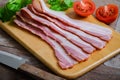 Raw sliced bacon on wooden board Royalty Free Stock Photo