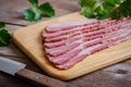 Raw sliced bacon on wooden board Royalty Free Stock Photo