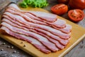 Raw sliced bacon on wooden board Royalty Free Stock Photo
