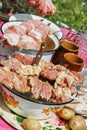 Raw sliced meat on the table, barbecue outdoors.