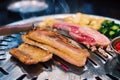 raw sliced pork on hot pan with smoke Korean-Style BBQ in a Korean restaurant Royalty Free Stock Photo