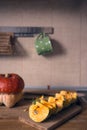 Raw, sliced pumpkin on wood in domestic kitchen